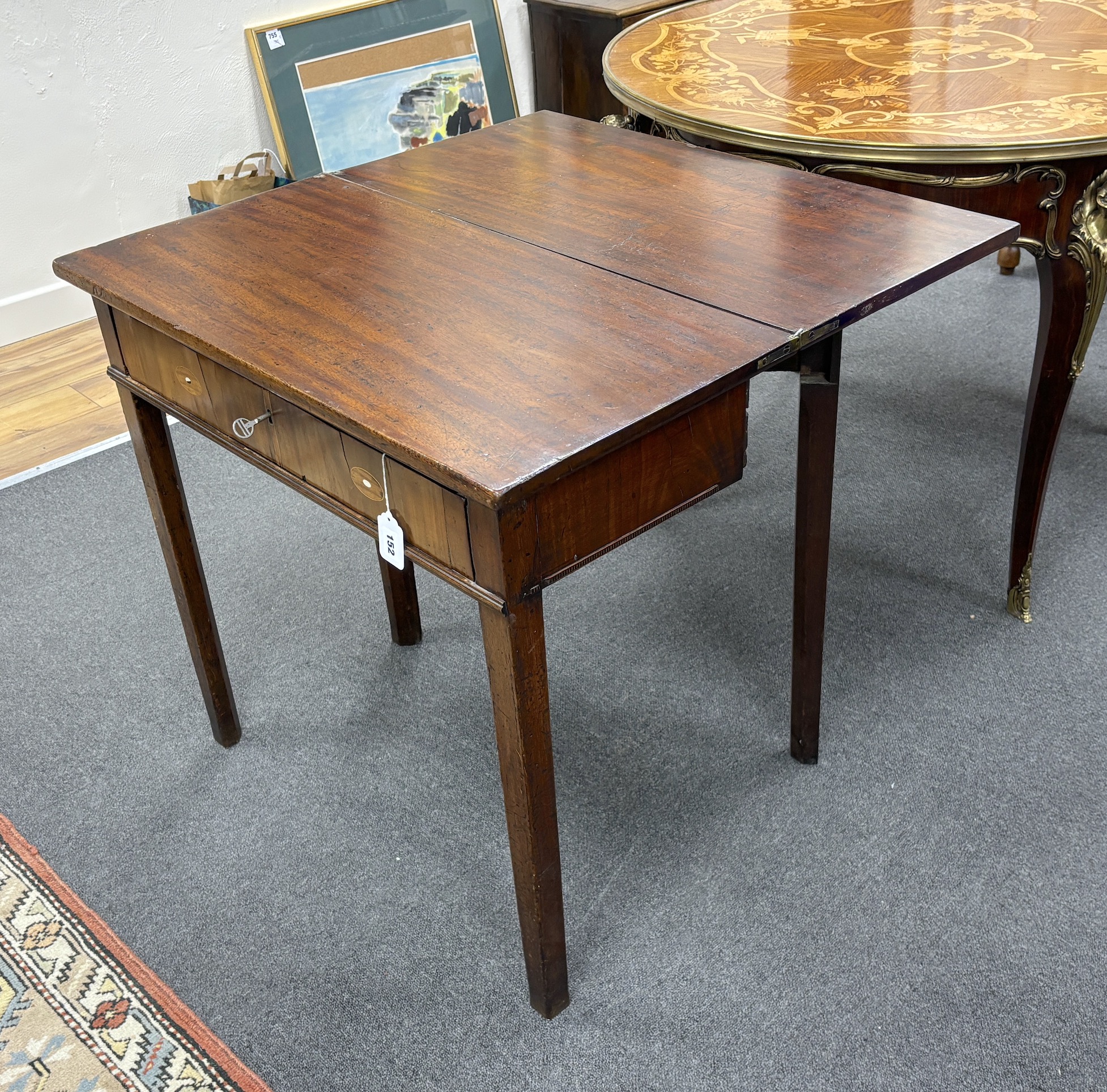 A George III rectangular mahogany folding tea table, width 75cm, depth 37cm, height 72cm.